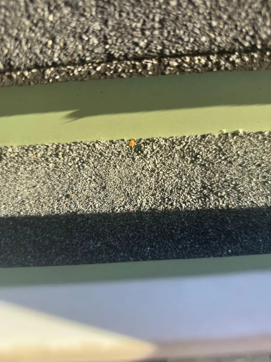Closeup of roof edge flashing and adjacent granular shingle surfaces, Southern Premier Roofing work near Nicholson GA