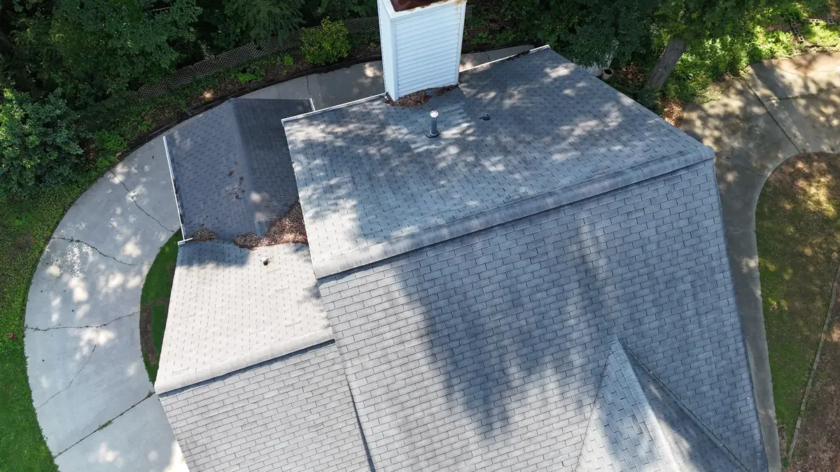Aerial view of completed shingle roof with chimney and surrounding yard, Southern Premier Roofing work near Nicholson GA