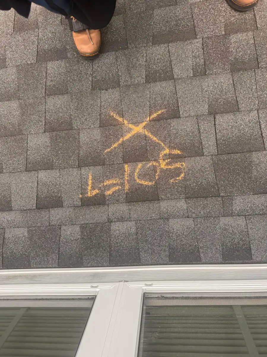 Roof shingles show marked chalk lines and localized surface damage, Southern Premier Roofing work near Norcross GA