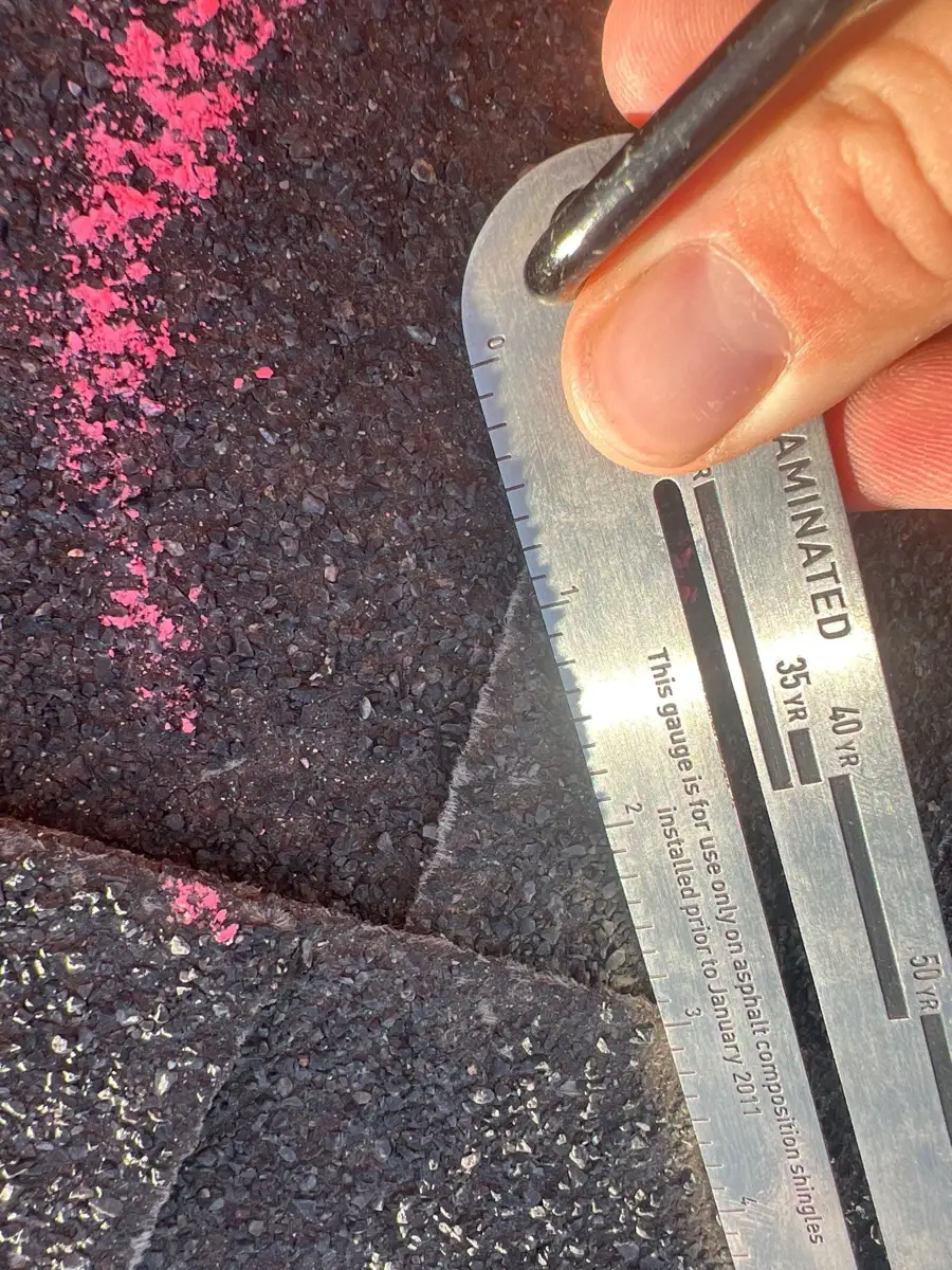 Roof shingle seam examined with measuring gauge and markings, Southern Premier Roofing work near North High Shoals GA