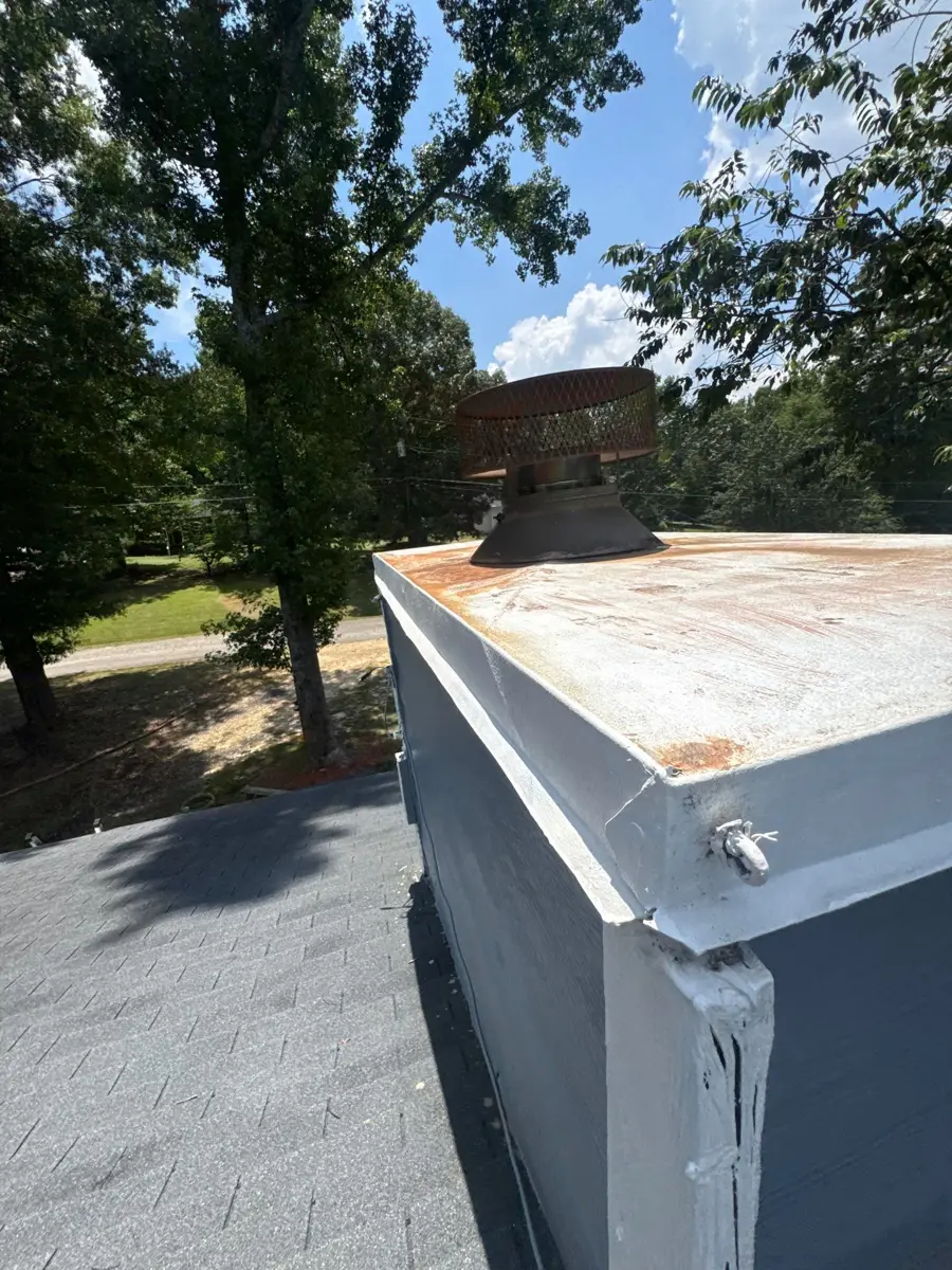 Metal roof edge flashing beside adjacent shingle roof surface, Southern Premier Roofing work near Oakwood GA
