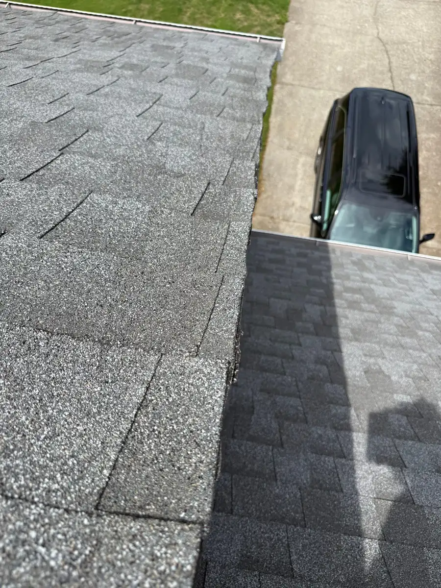 Completed shingle roof section viewed above driveway and parked vehicle, Southern Premier Roofing work near Oakwood GA