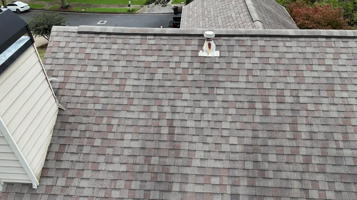 Completed shingle roof viewed overhead with chimney and surrounding roof sections, Southern Premier Roofing work near Oxford GA