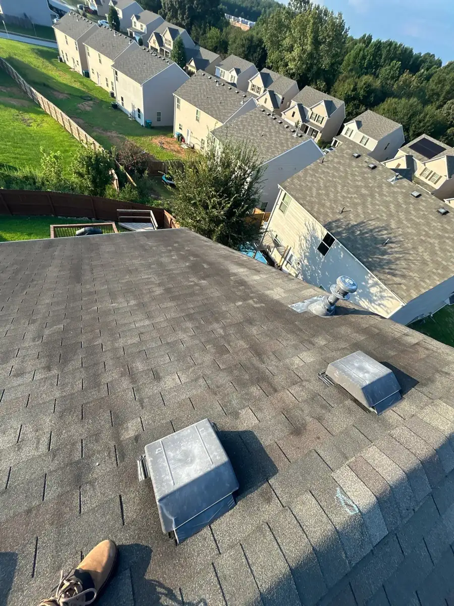 Completed shingle roof with rooftop vents overlooking suburban homes, Southern Premier Roofing work near Rutledge GA