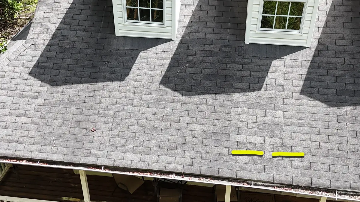 Roof shingles show several highlighted uneven areas below dormers, Southern Premier Roofing work near Stone Mountain GA