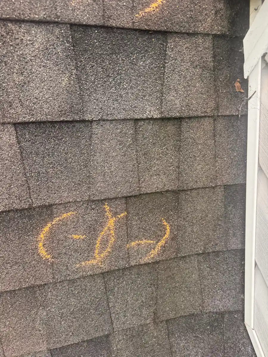 Close-up of marked weathered shingles along roof edge, Southern Premier Roofing work near Sugar Hill GA