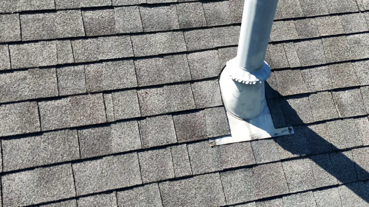 Roof vent pipe with metal flashing surrounded by asphalt shingles, Southern Premier Roofing work near Tucker GA