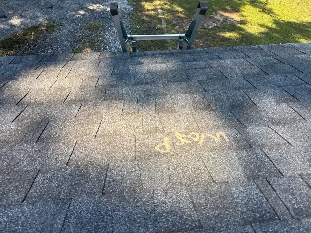 Close view of weathered asphalt shingles with marked roof damage, Southern Premier Roofing work near Winder GA