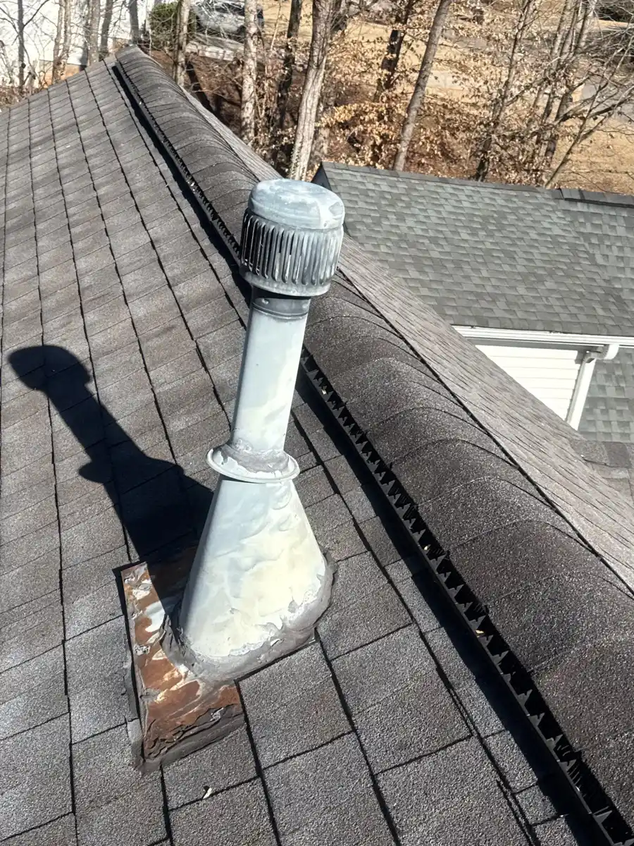 Metal vent flashing and ridge vent visible on shingle roof, Southern Premier Roofing work near Winder GA