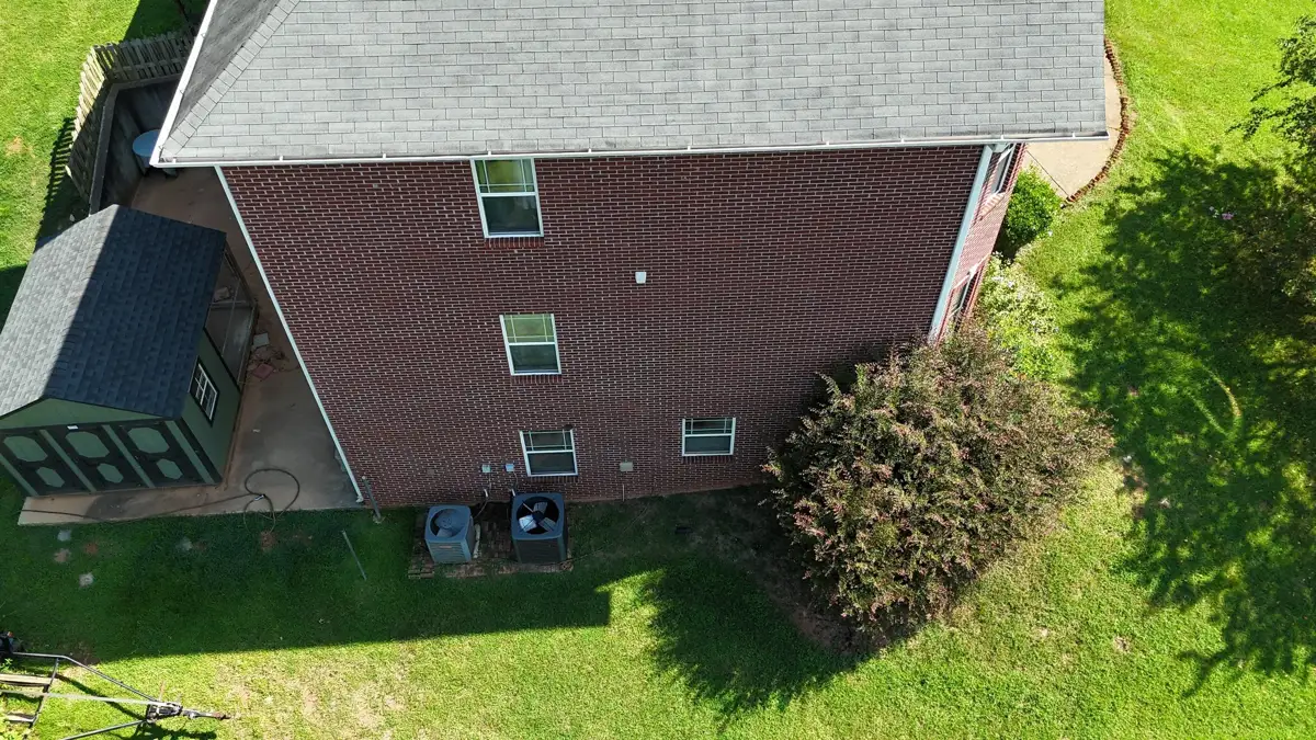 Aerial view of completed shingle roof on brick-sided house, Southern Premier Roofing work near Winder GA