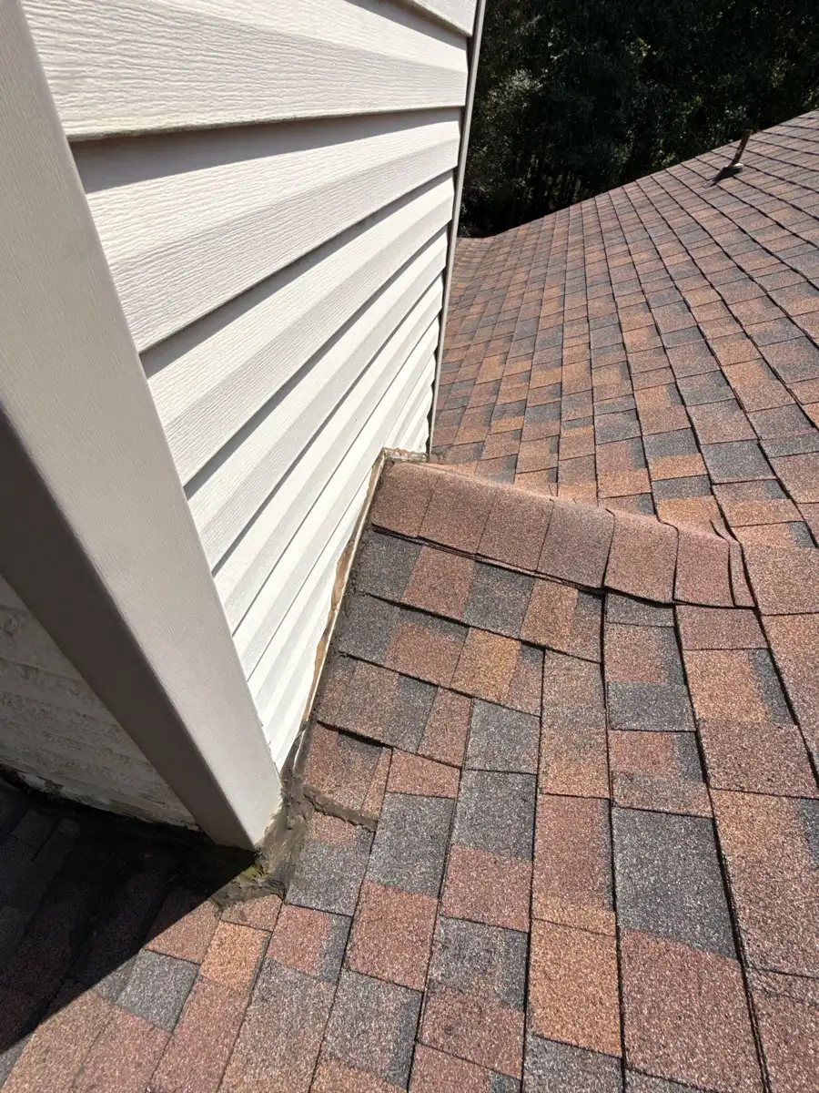 Clean architectural shingles meeting white siding along roof edge, Southern Premier Roofing work near Auburn GA