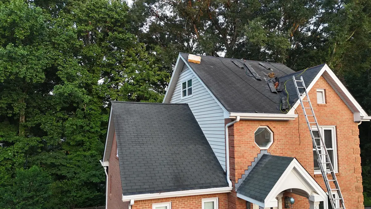 Completed shingle roof visible on brick and siding house, Southern Premier Roofing work near Auburn GA