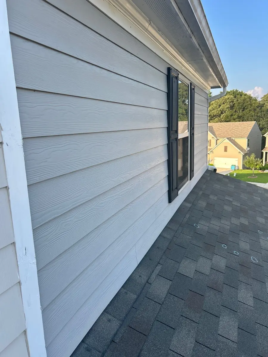 Gray shingle roof edge alongside clean white siding, Southern Premier Roofing work near Bethlehem GA