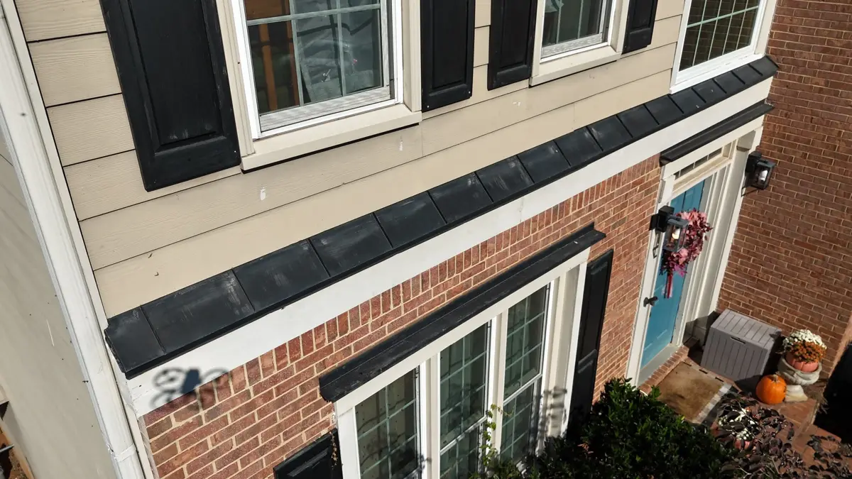 Wide view of black flashing installed across brick and siding transition, Southern Premier Roofing work near Bogart GA