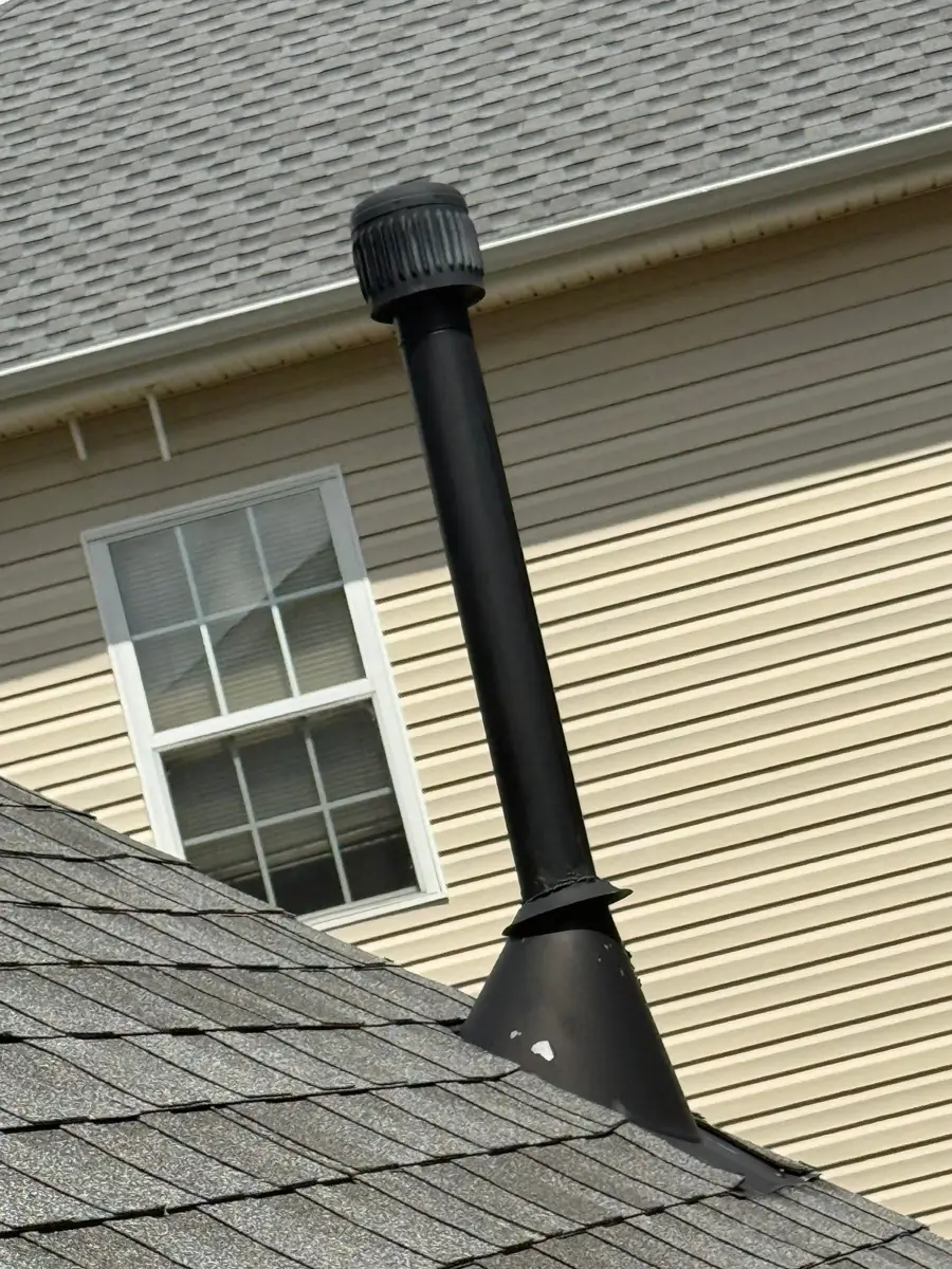 Black metal roof vent flashing beside siding and shingle roof, Southern Premier Roofing work near Bogart GA