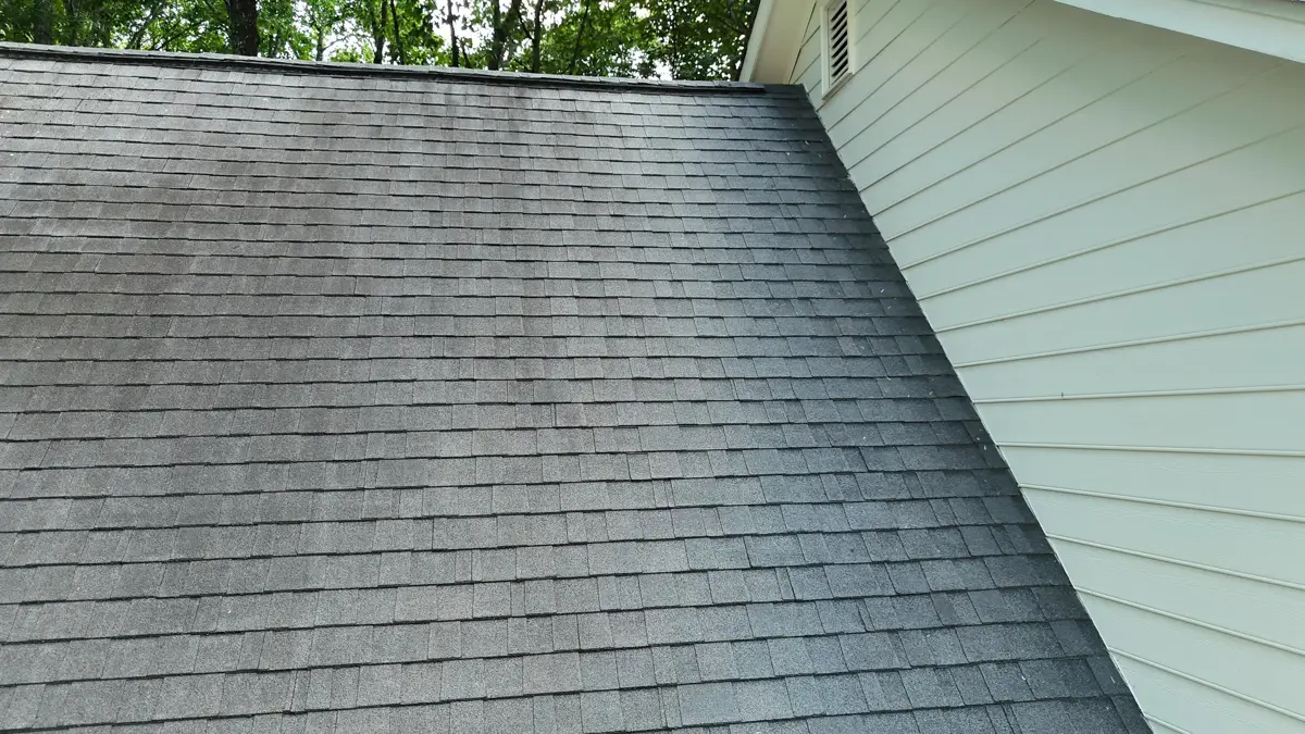Clean shingle roof slope meeting light siding wall, Southern Premier Roofing work near Winder GA