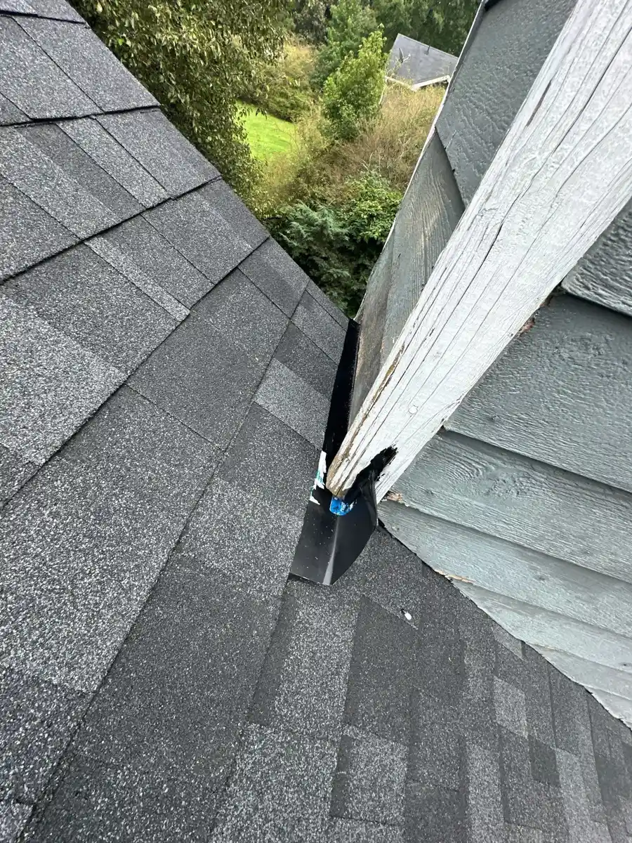 Shingle roof junction with siding and exposed metal flashing, Southern Premier Roofing work near Carl GA